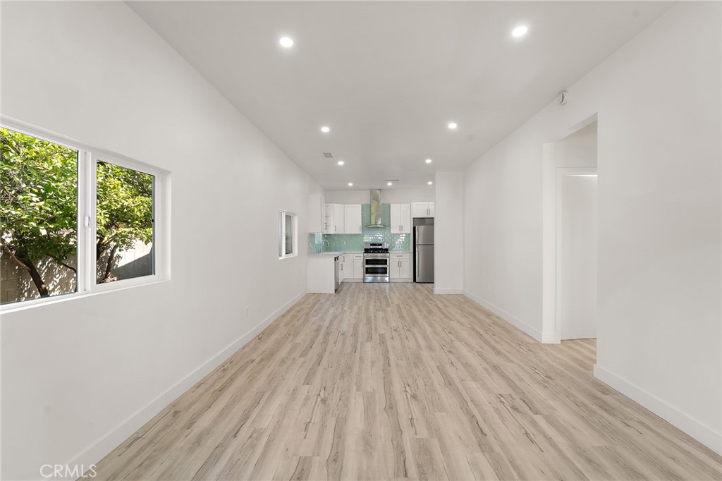 10730 Strathern Street Sun Valley, CA 91352 - Photo 4 of 57 a view of a big room with wooden floor and windows
