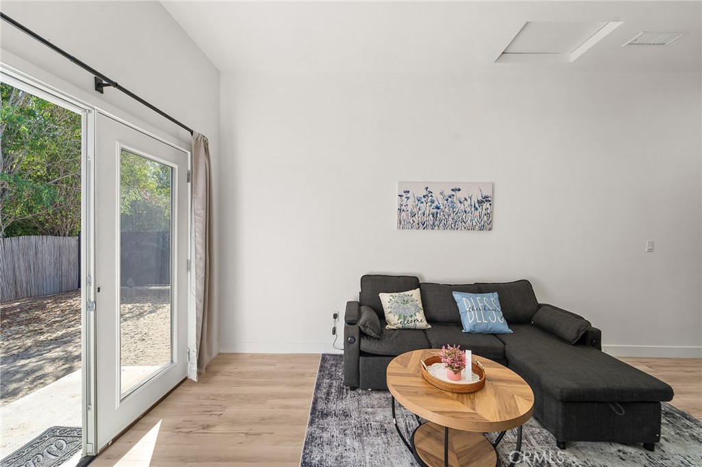 10730 Strathern Street Sun Valley, CA 91352 - Photo 41 of 57 a living room with furniture a rug and a large window