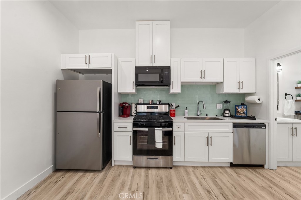 10730 Strathern Street Sun Valley, CA 91352 - Photo 42 of 57 a kitchen with a refrigerator and a stove top oven