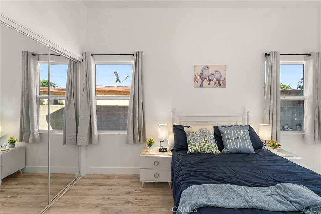 10730 Strathern Street Sun Valley, CA 91352 - Photo 49 of 57 a bedroom with a bed and wooden floor