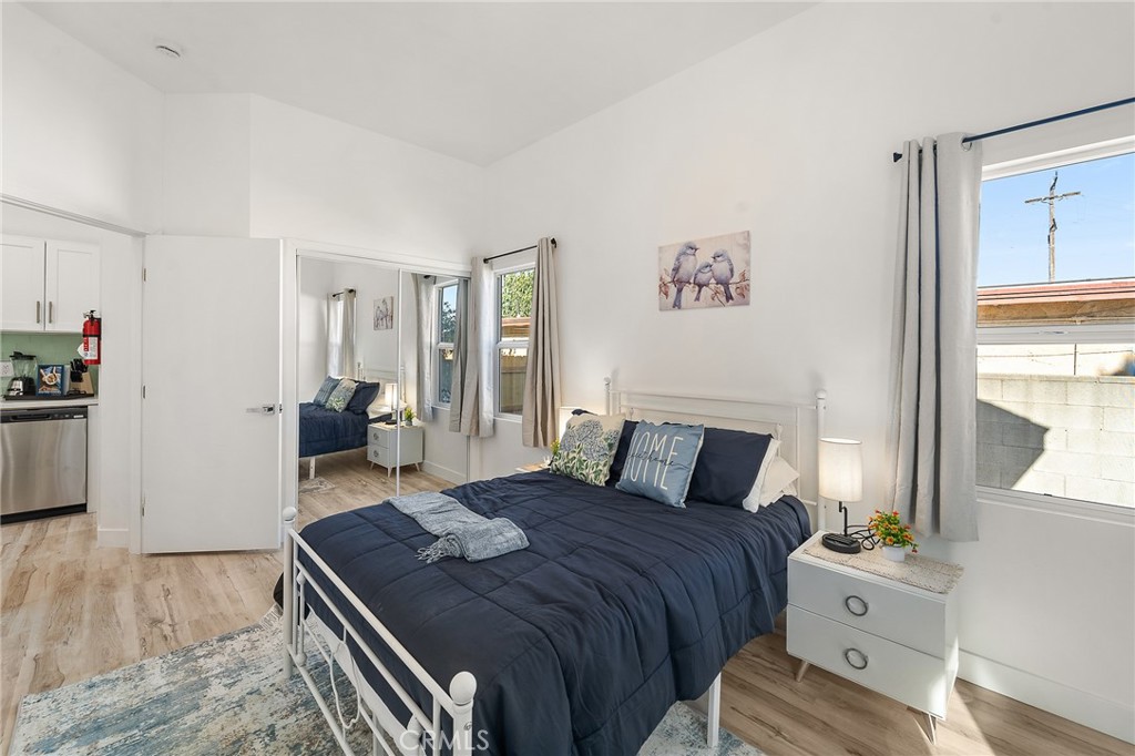 10730 Strathern Street Sun Valley, CA 91352 - Photo 50 of 57 a bedroom with a bed and wooden floor