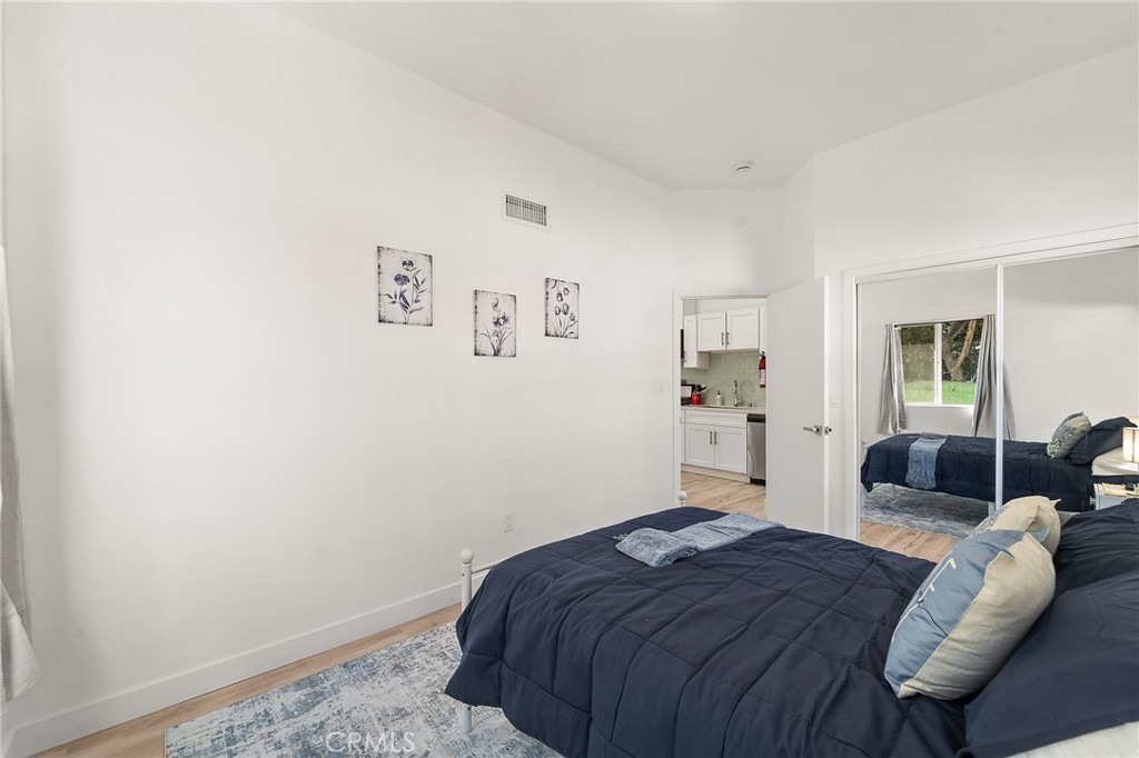 10730 Strathern Street Sun Valley, CA 91352 - Photo 51 of 57 a bedroom with a bed and wooden floor
