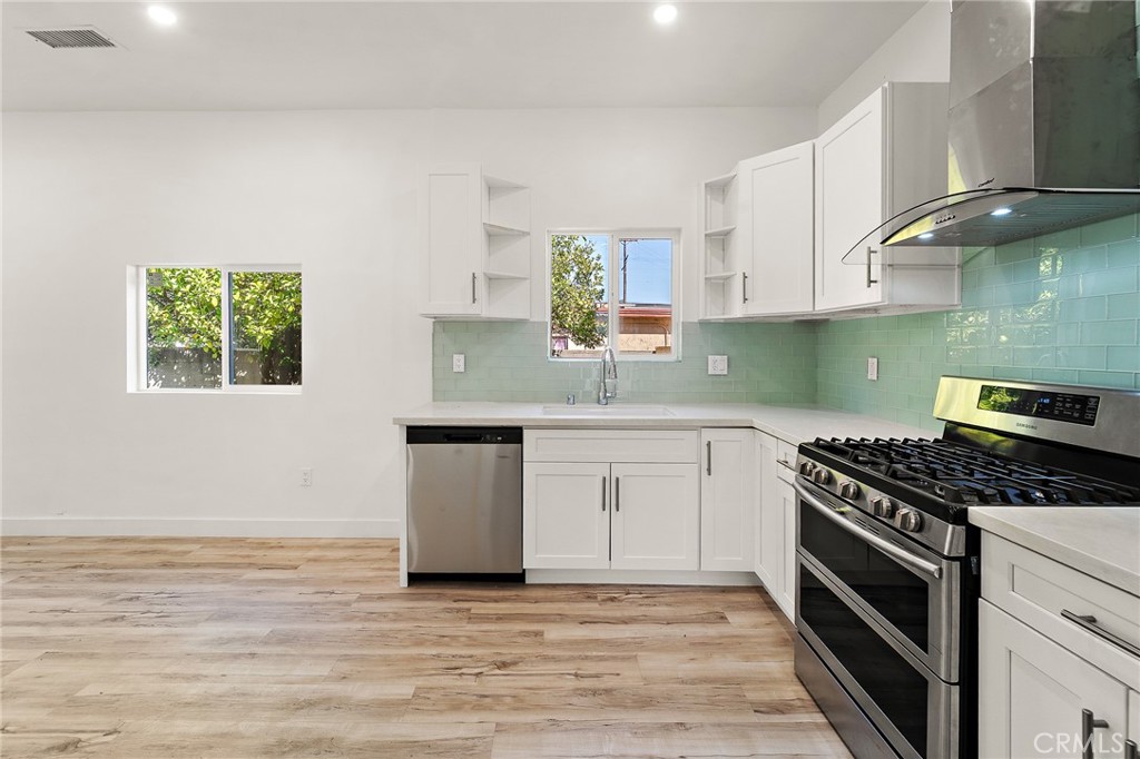 10730 Strathern Street Sun Valley, CA 91352 - Photo 7 of 57 a kitchen with granite countertop a stove a sink and a granite counter tops