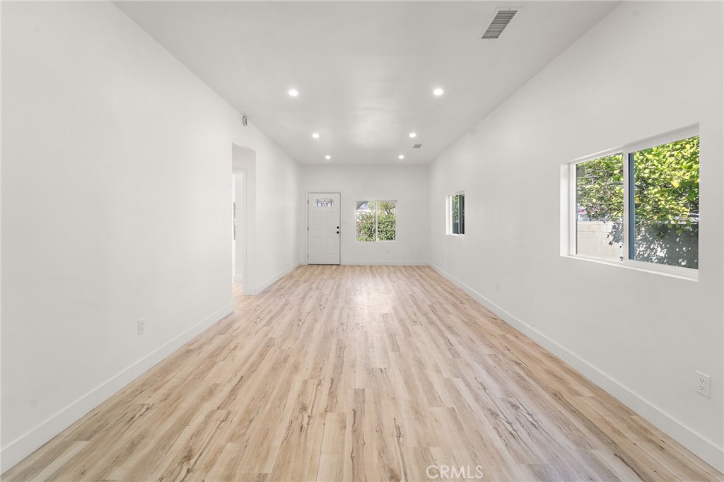 10730 Strathern Street Sun Valley, CA 91352 - Photo 8 of 57 an empty room with wooden floor and windows