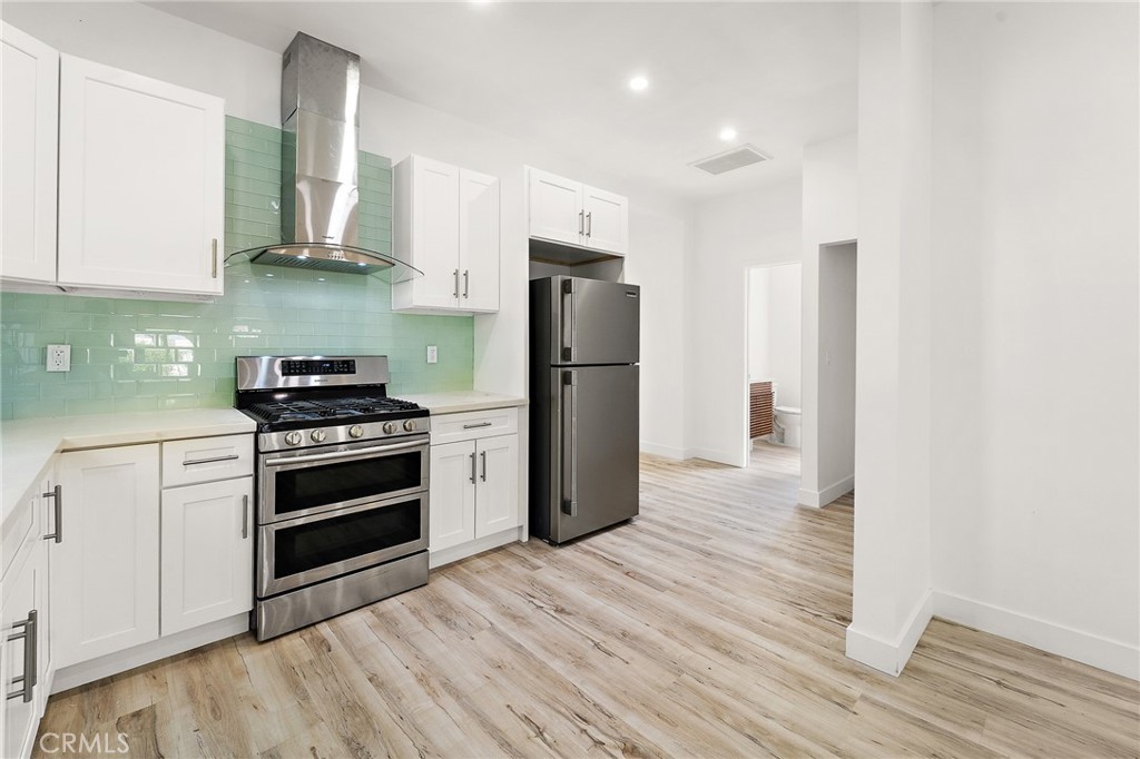10730 Strathern Street Sun Valley, CA 91352 - Photo 9 of 57 a kitchen with stainless steel appliances a refrigerator stove and microwave