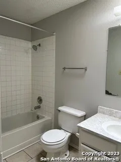 a white toilet sitting next to a bath tub and a shower
