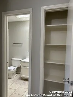 a bathroom with a toilet and a vanity
