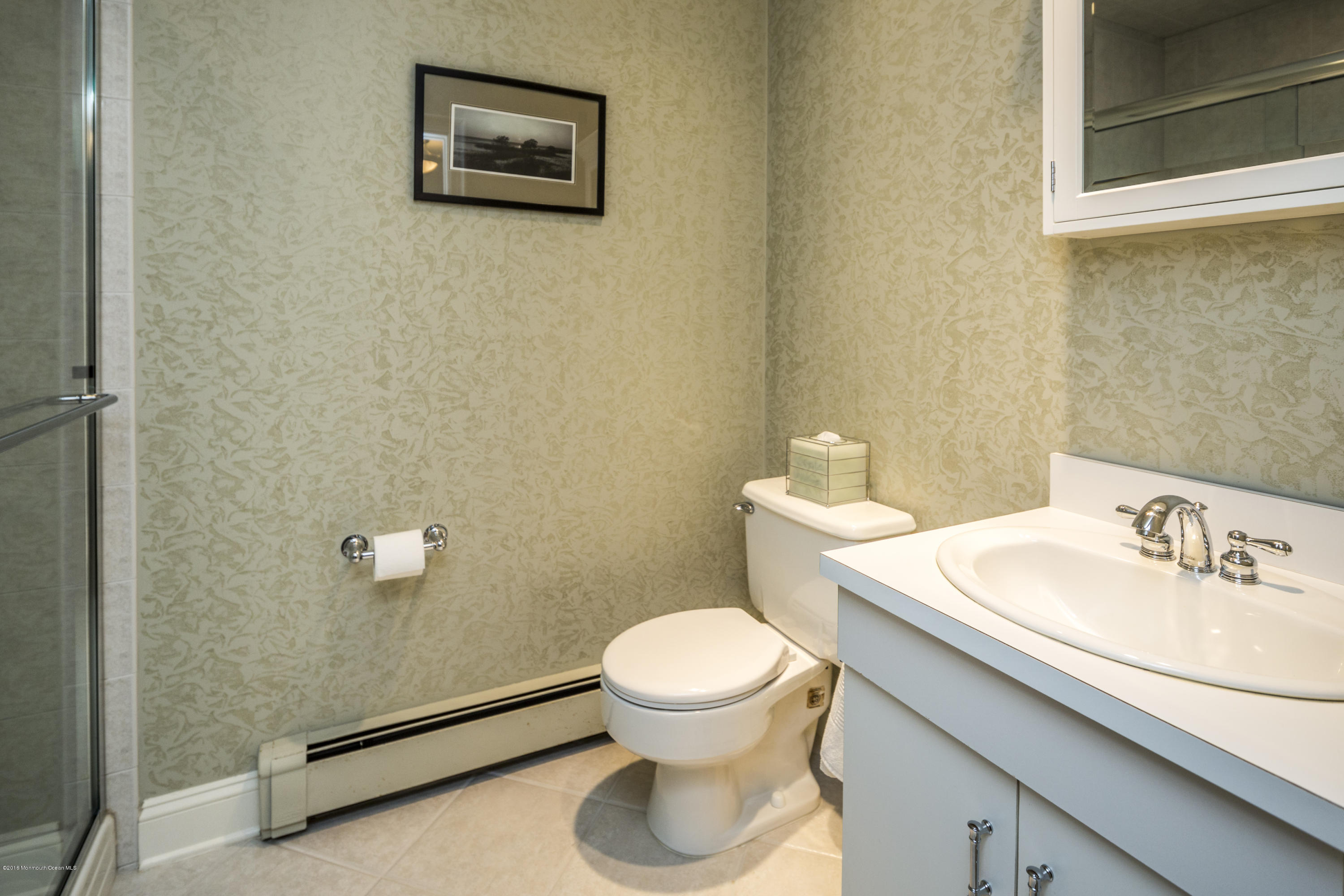 41 White Street Long Branch, NJ 07740 - Photo 16 of 29 a bathroom with a sink a toilet and a mirror