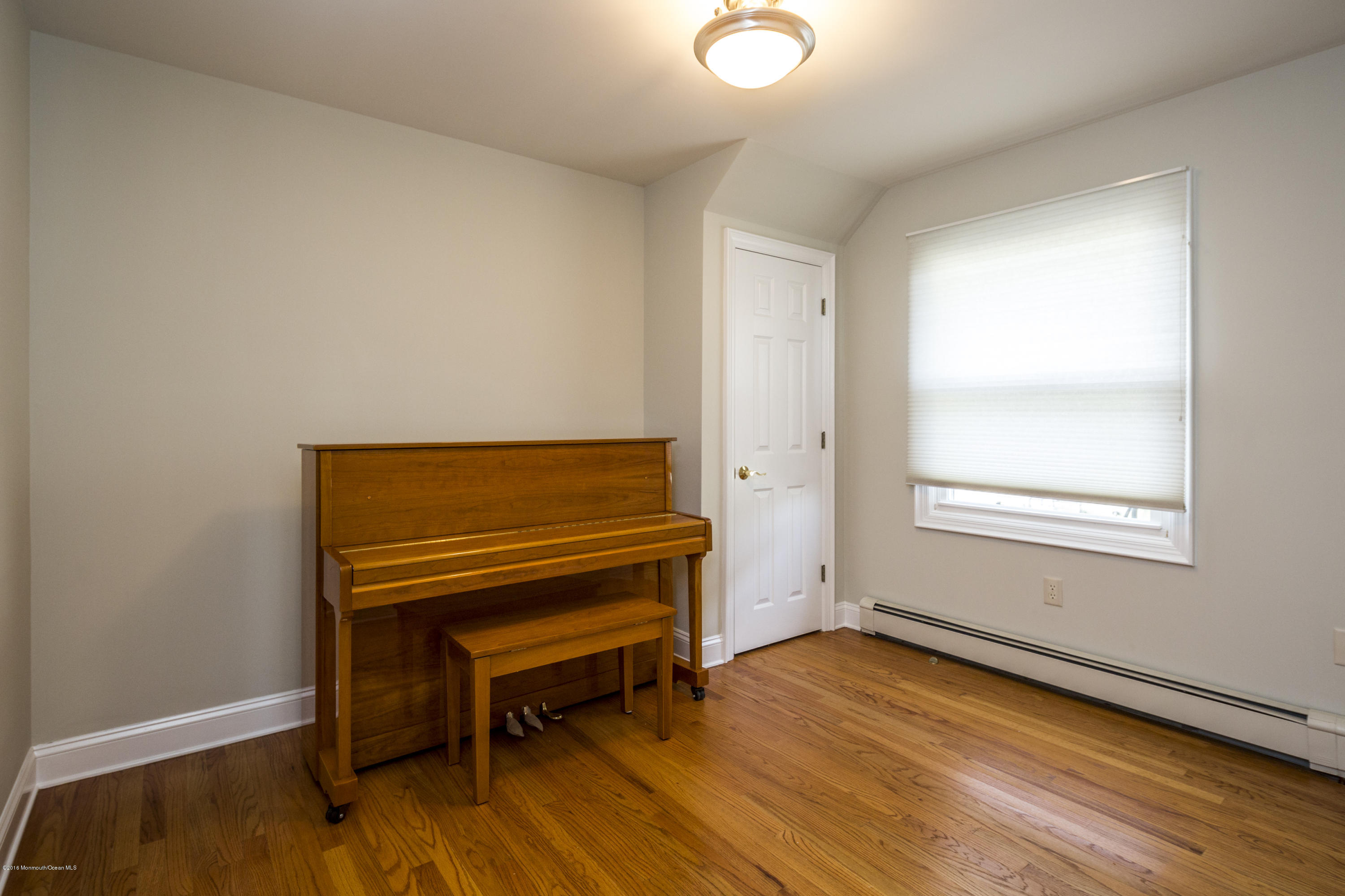 41 White Street Long Branch, NJ 07740 - Photo 17 of 29 a view of a room with wooden floor and a window