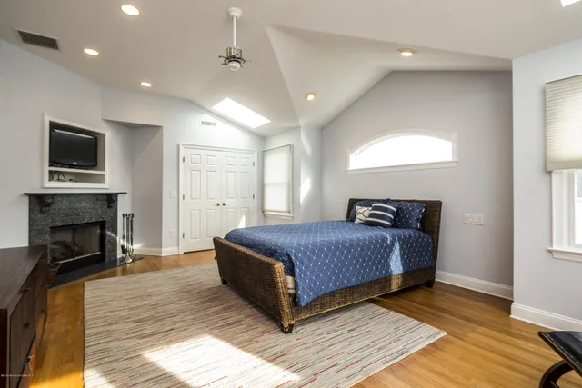 a spacious bedroom with a bed and a fireplace