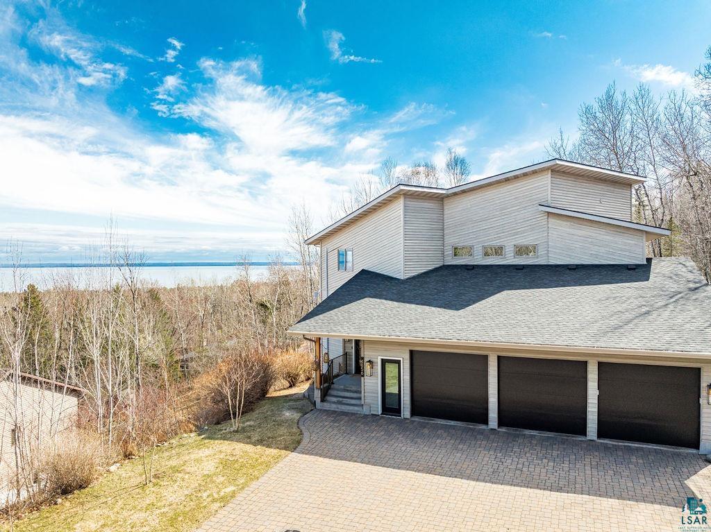 4856 Kingston Street Duluth, MN 55804 - Photo 61 of 88 Contemporary home featuring light-toned horizontal siding and a dark shingled roof