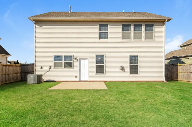 a view of a house with a yard and sitting area