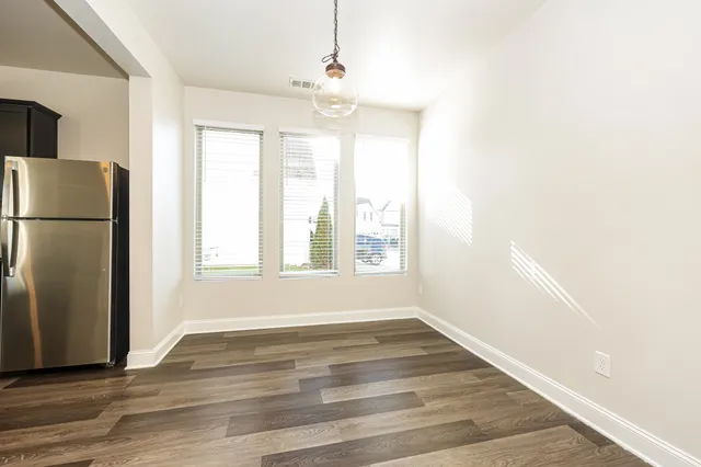 a view of a livingroom with a dishwasher cabinets and wooden floor