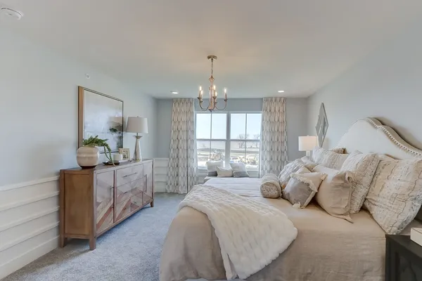 a spacious bedroom with a large bed and a window
