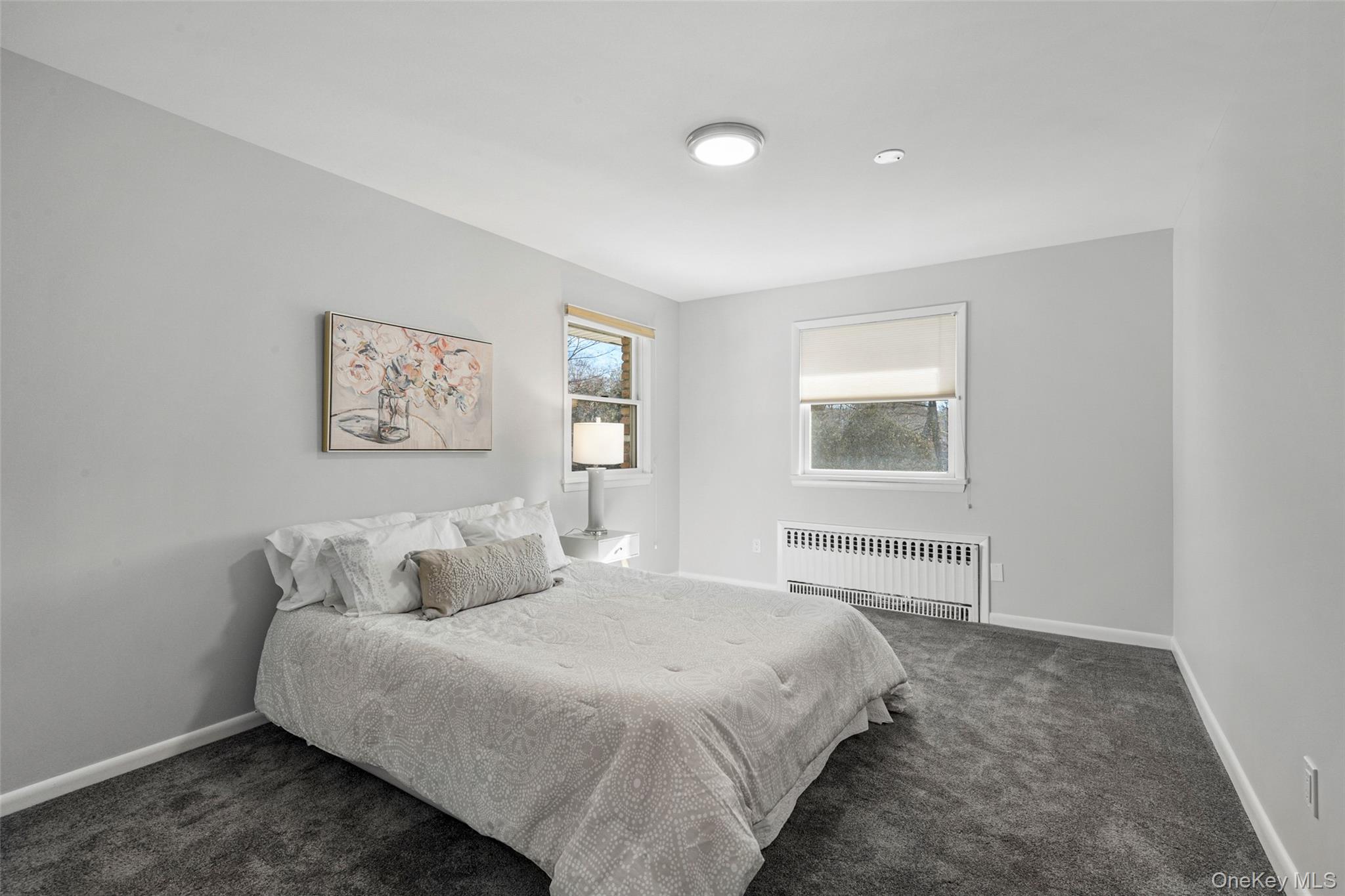 60 Overhill Road New Rochelle, NY 10804 - Photo 26 of 50 a bedroom with bed and painting on the wall