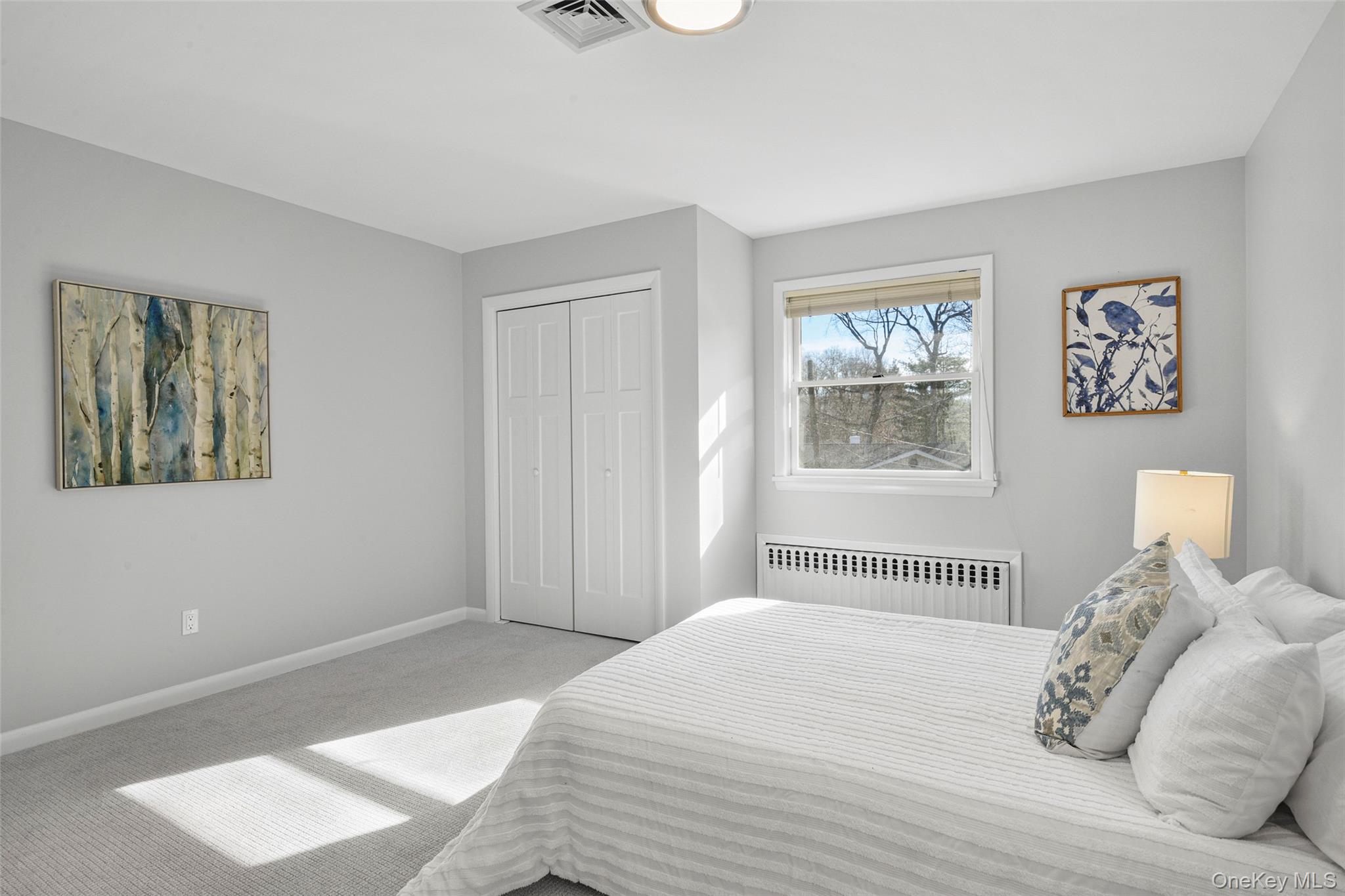 60 Overhill Road New Rochelle, NY 10804 - Photo 29 of 50 a bedroom with a bed and a painting on the wall