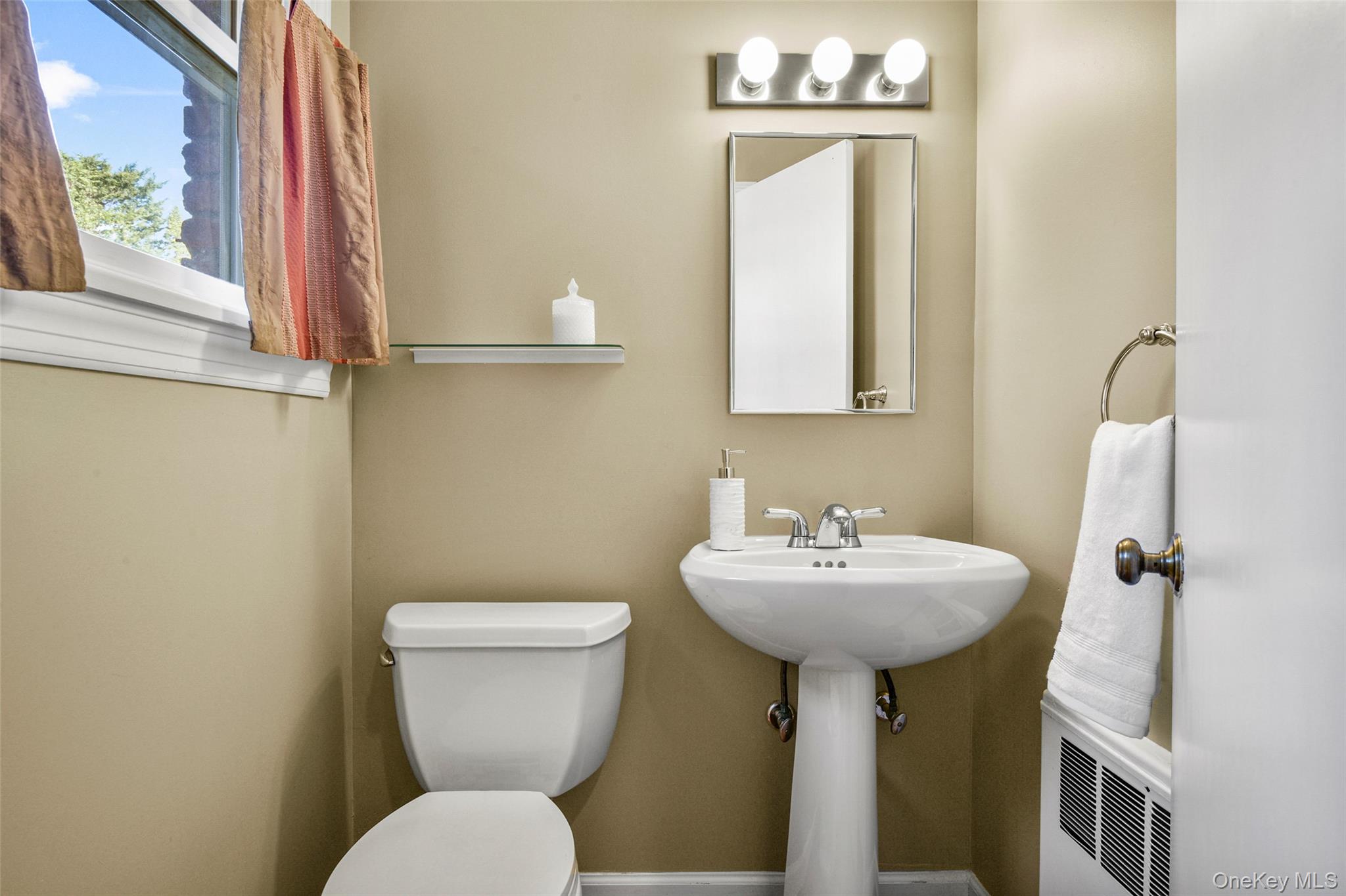 60 Overhill Road New Rochelle, NY 10804 - Photo 37 of 50 a bathroom with a sink mirror and toilet
