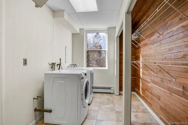 an aerial view of house with yard and mountain view in back
