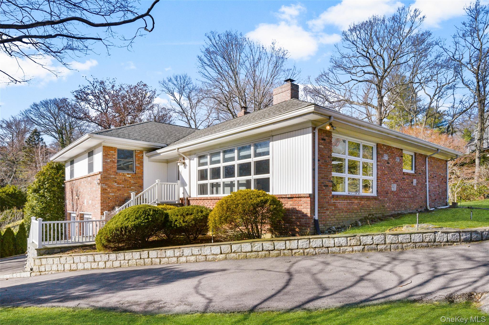 60 Overhill Road New Rochelle, NY 10804 - Photo 5 of 50 a front view of a house with a yard and potted plants