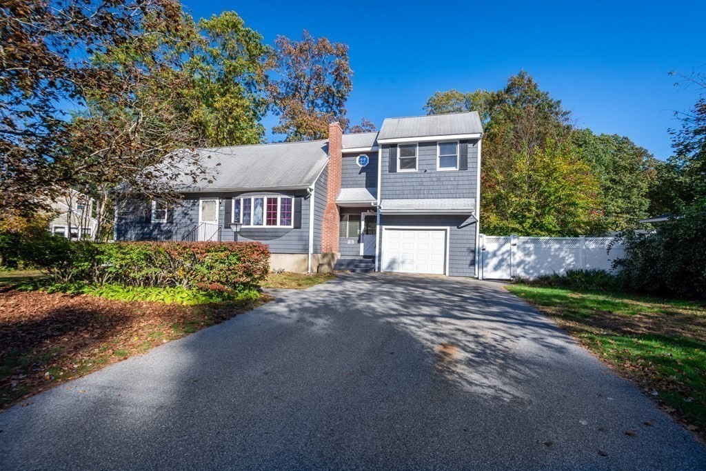 23 Fairmeadow Road Wilmington, MA 01887 - Photo 1 of 24 a view of a house with a yard and potted plants