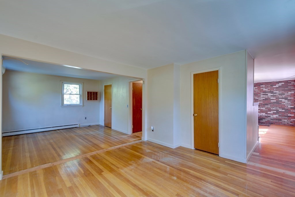 23 Fairmeadow Road Wilmington, MA 01887 - Photo 11 of 24 a view of an empty room with window and wooden floor