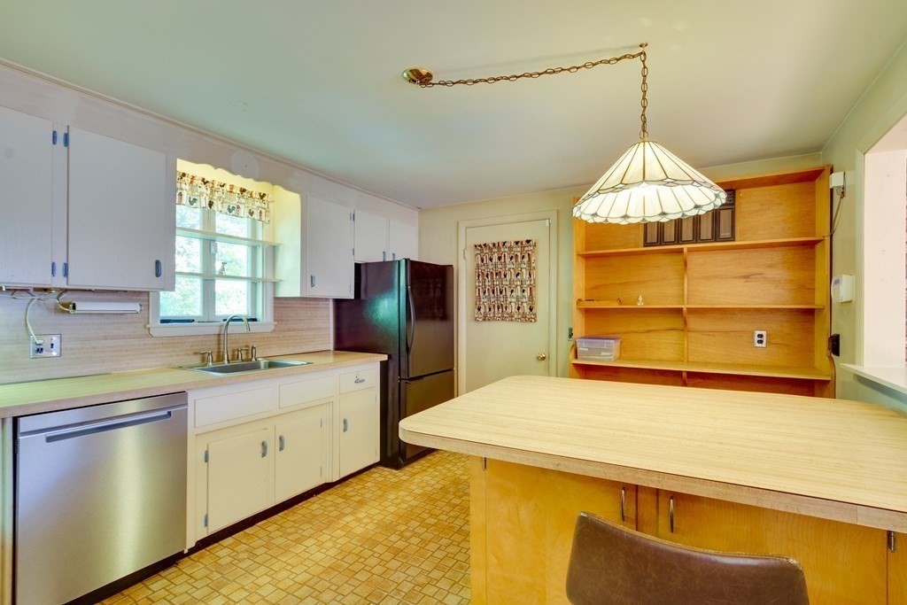 23 Fairmeadow Road Wilmington, MA 01887 - Photo 2 of 24 a kitchen with a sink and a refrigerator