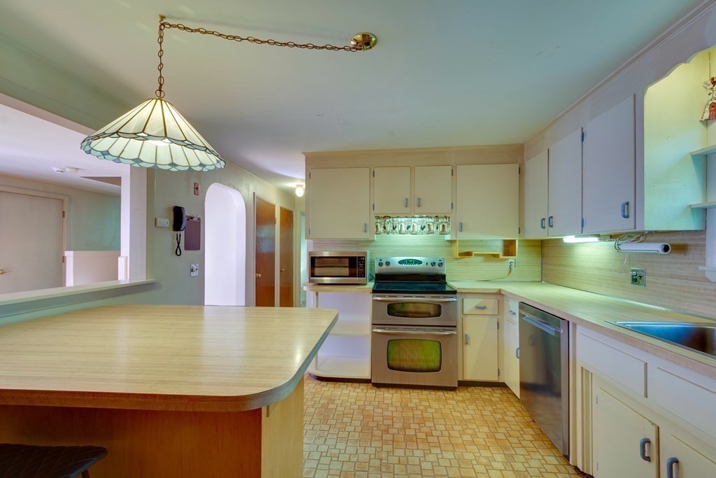 23 Fairmeadow Road Wilmington, MA 01887 - Photo 3 of 24 a kitchen with a sink a stove and cabinets