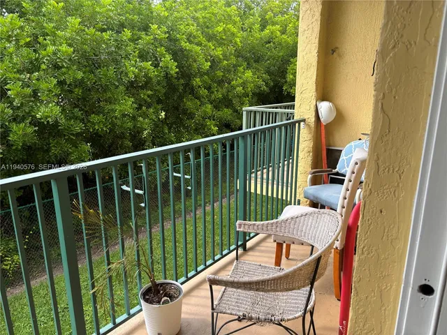 a view of a chair and tables in the balcony