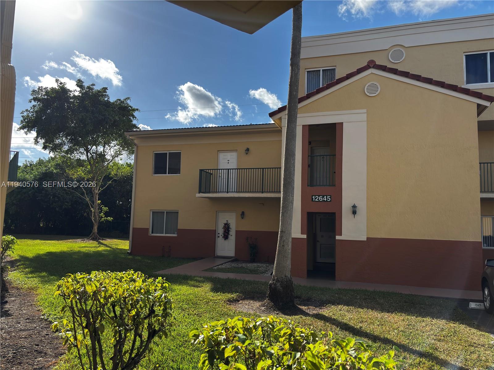12645 Southwest 91st Street, Unit 2014 Miami, FL 33186 - Photo 15 of 15 a front view of a house with a yard