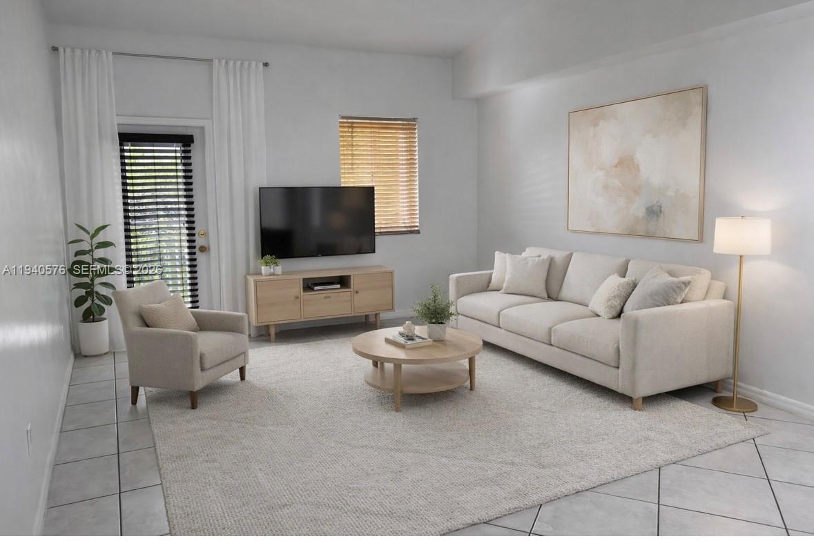 12645 Southwest 91st Street, Unit 2014 Miami, FL 33186 - Photo 4 of 15 a living room with furniture and a flat screen tv