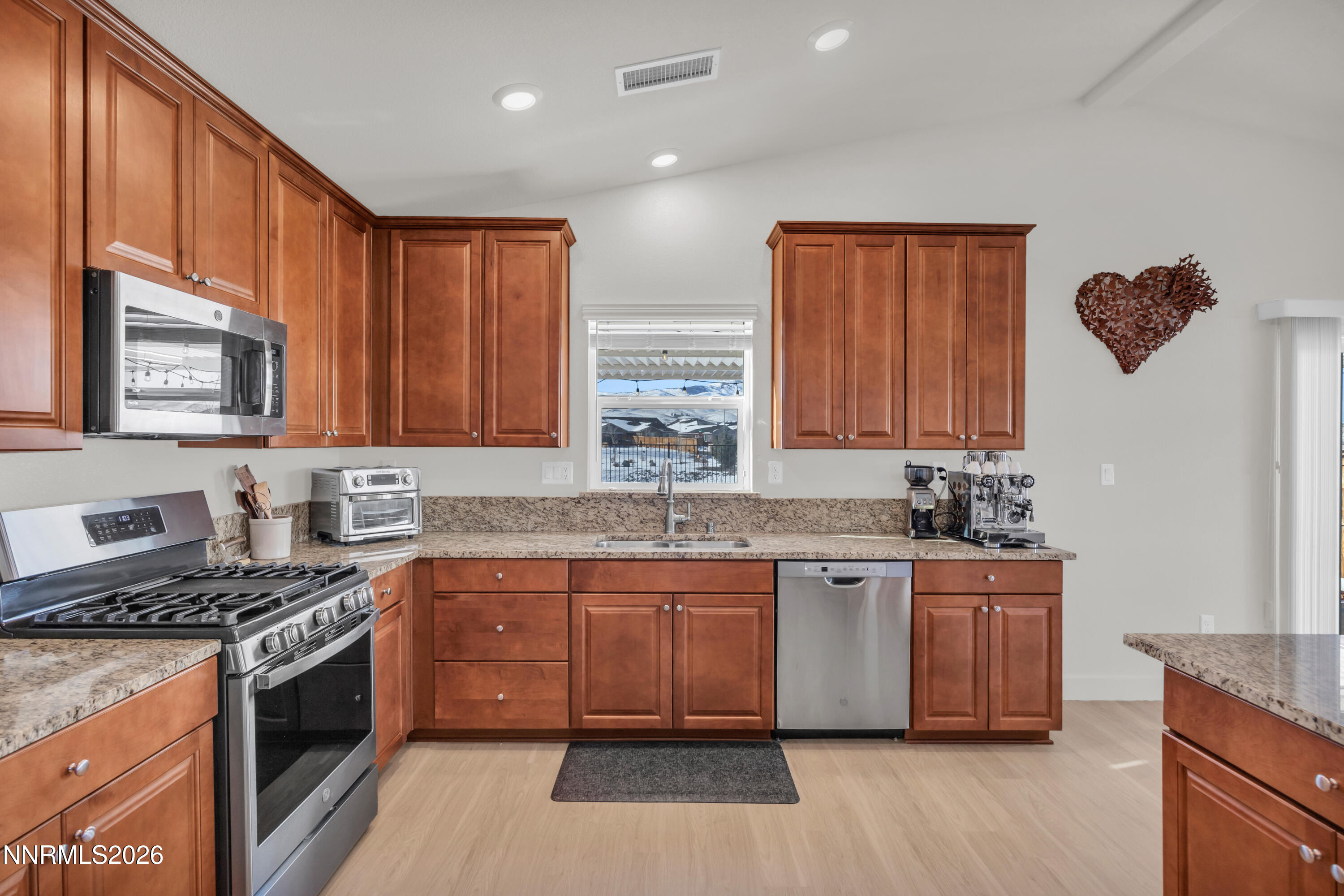 7445 Hundred Acre Drive Reno, NV 89506 - Photo 13 of 41 a kitchen with stainless steel appliances granite countertop a stove a sink and a microwave