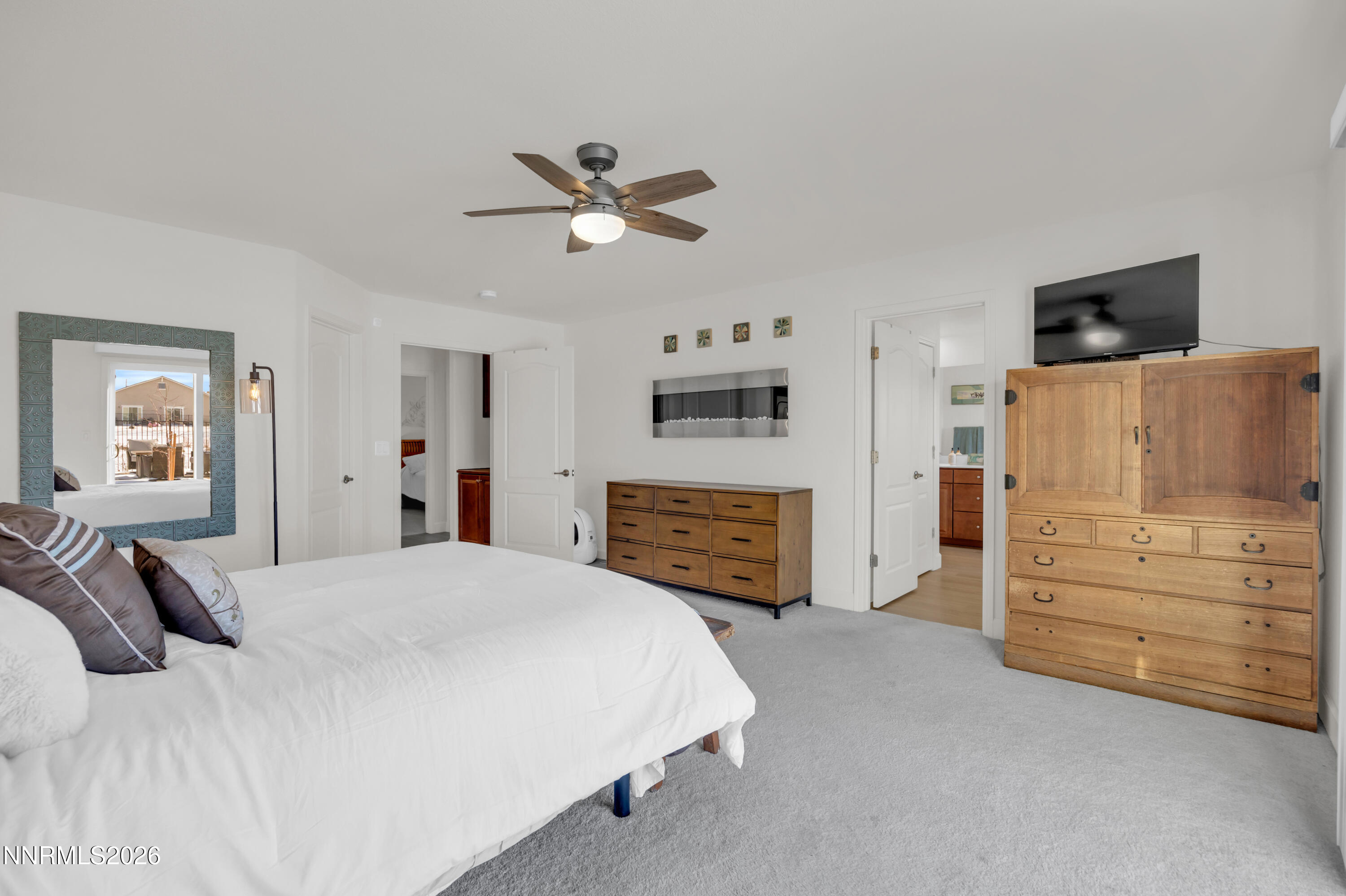 7445 Hundred Acre Drive Reno, NV 89506 - Photo 16 of 41 a spacious bedroom with a bed and a flat screen tv