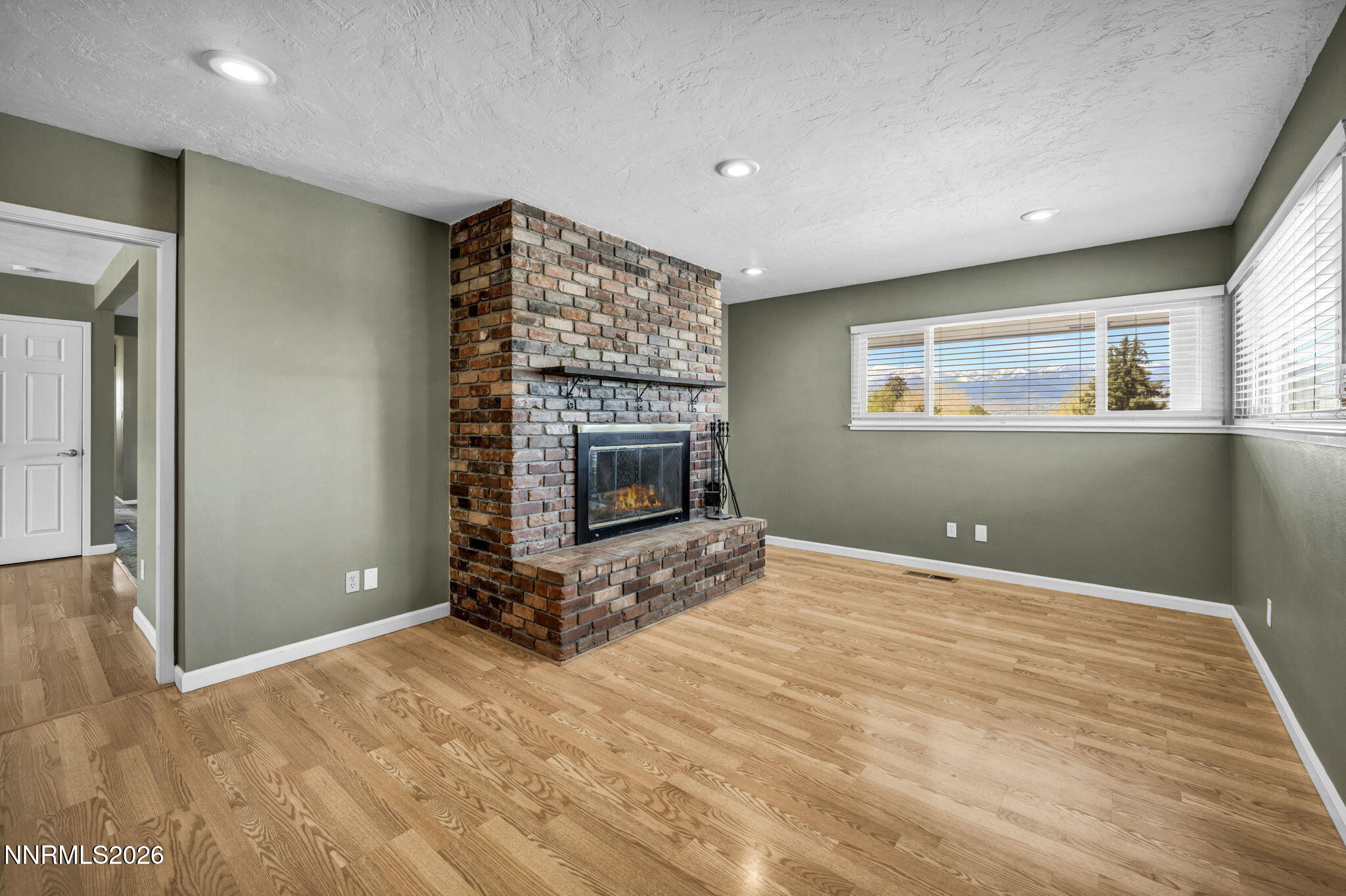 14190 Rim Rock Drive Reno, NV 89521 - Photo 11 of 68 a view of empty room with fireplace and window