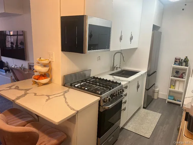 a kitchen with a sink stove and cabinets