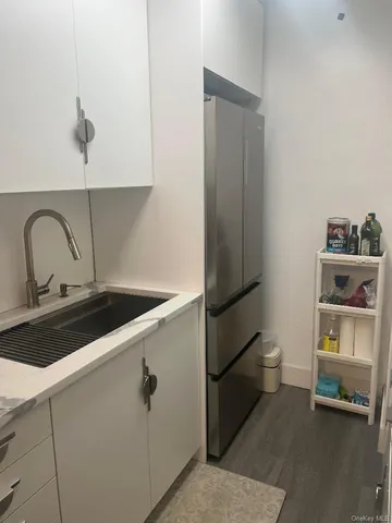 a close view of a sink a counter and appliances in a kitchen