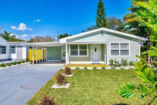 a front view of a house with a yard outdoor seating and garage