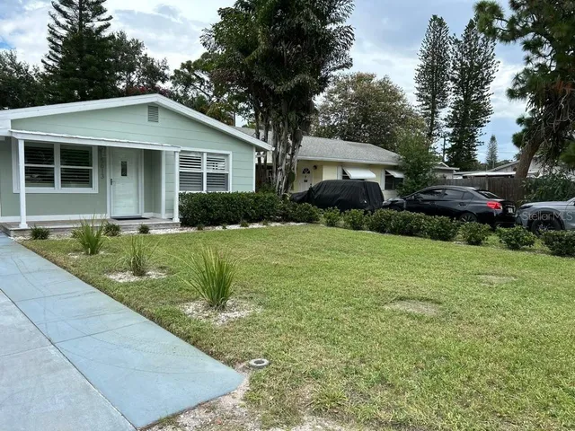 a front view of house with yard and green space