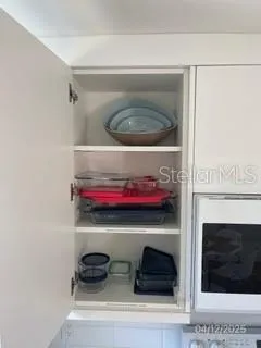 a kitchen with a stove and a potted plant