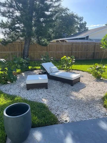a view of a porch with furniture and garden