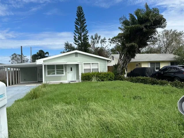 a view of a porch with furniture and garden
