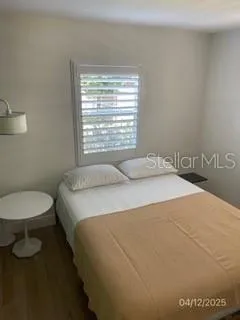 a bedroom with a bed and a mirror