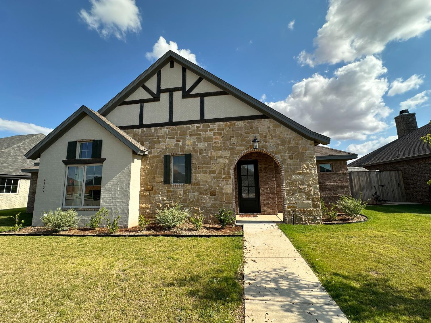 a front view of a house with yard and garage