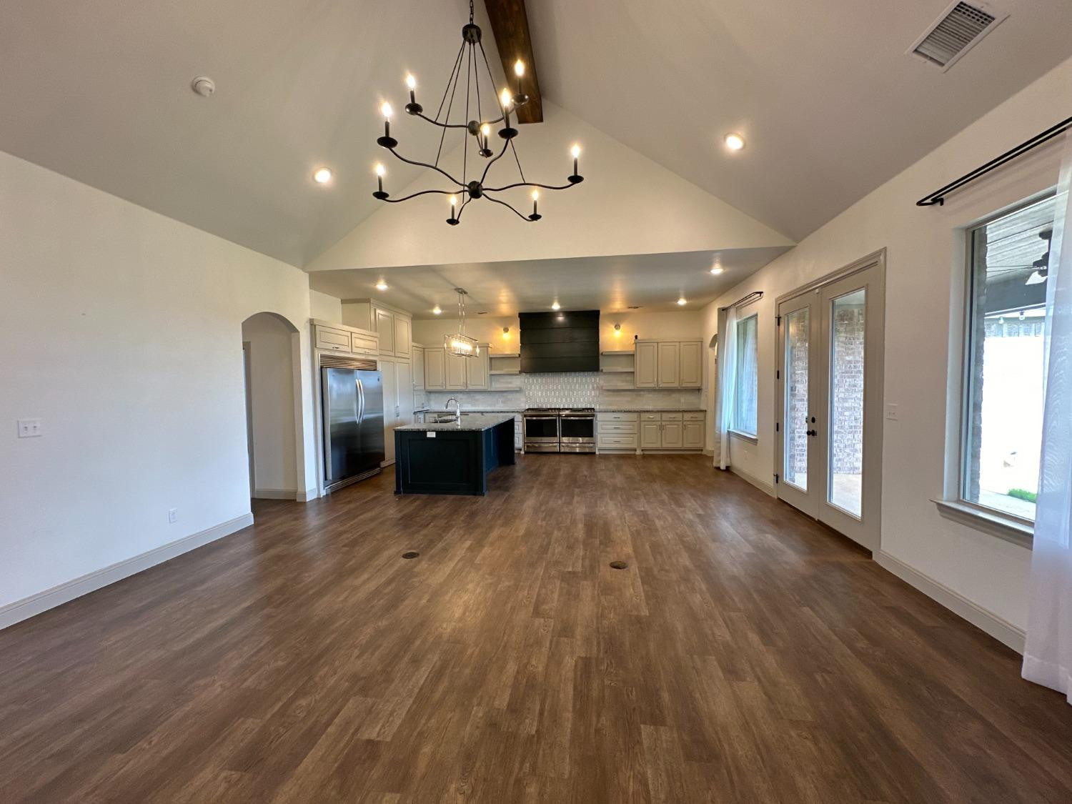 6959 103rd Street Lubbock, TX 79424 - Photo 11 of 49 a view of a kitchen with a sink stainless steel appliances and cabinets