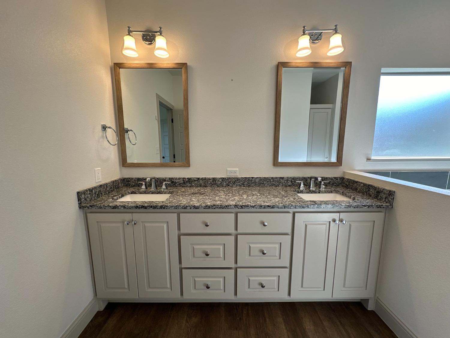 6959 103rd Street Lubbock, TX 79424 - Photo 15 of 49 a bathroom with a granite countertop sink and a mirror