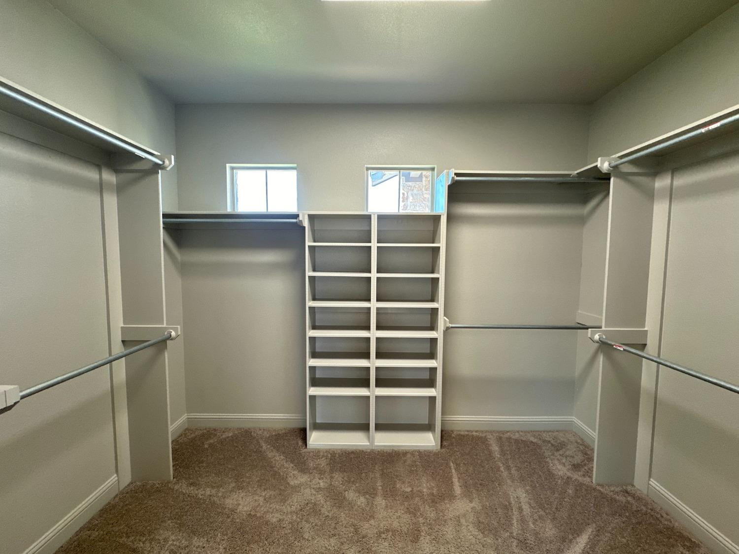6959 103rd Street Lubbock, TX 79424 - Photo 18 of 49 a view of walk in closet with empty racks