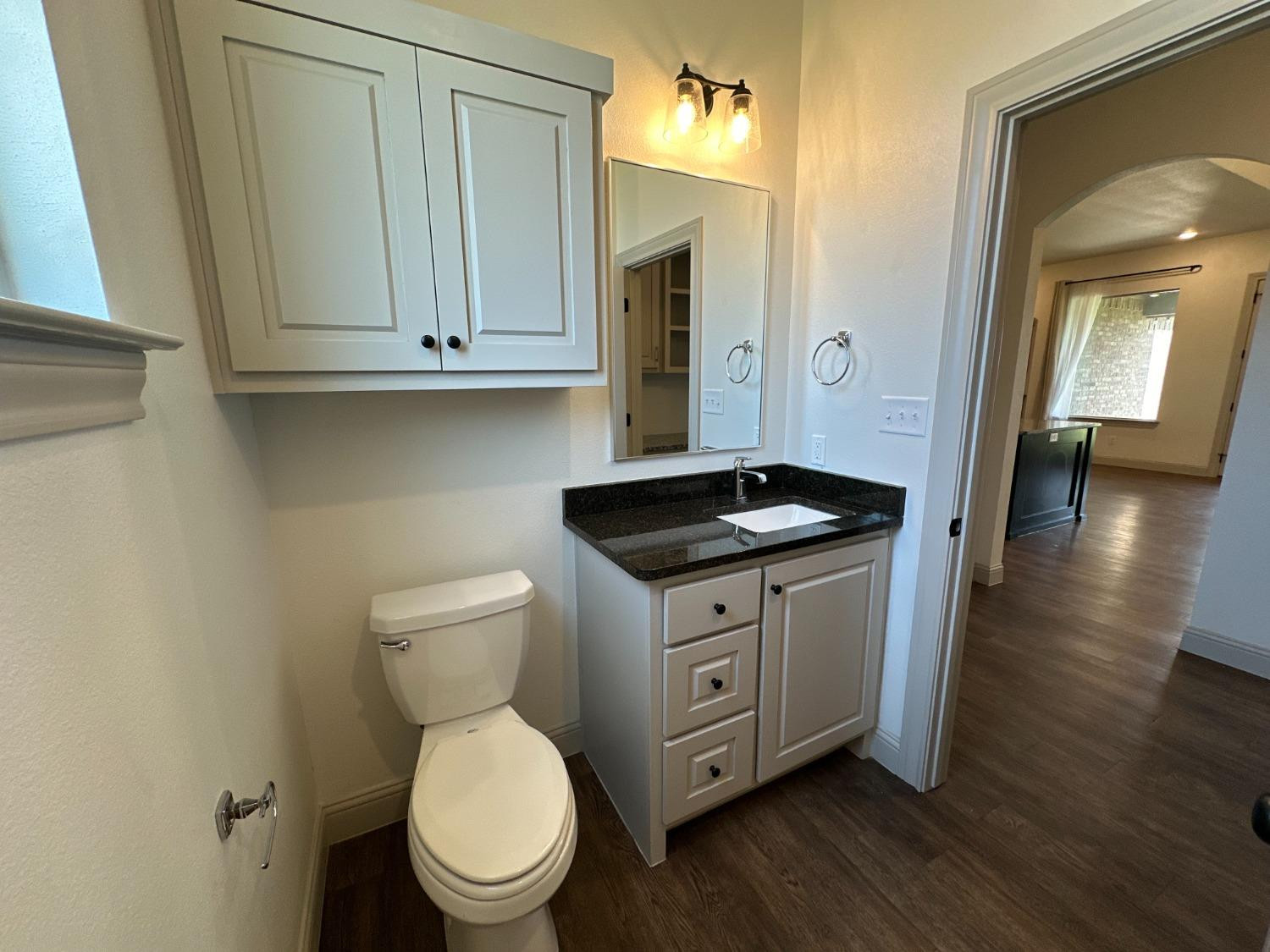 6959 103rd Street Lubbock, TX 79424 - Photo 23 of 49 a kitchen with a sink and a toilet