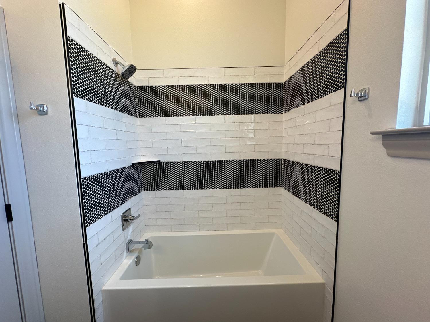 6959 103rd Street Lubbock, TX 79424 - Photo 24 of 49 a bathroom with a bathtub and window