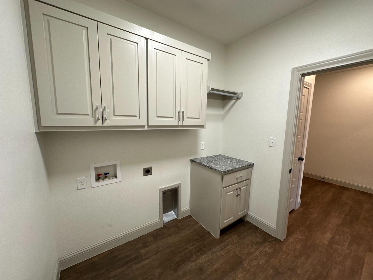 6959 103rd Street Lubbock, TX 79424 - Photo 30 of 49 a view of cabinets with wooden floor and cabinet
