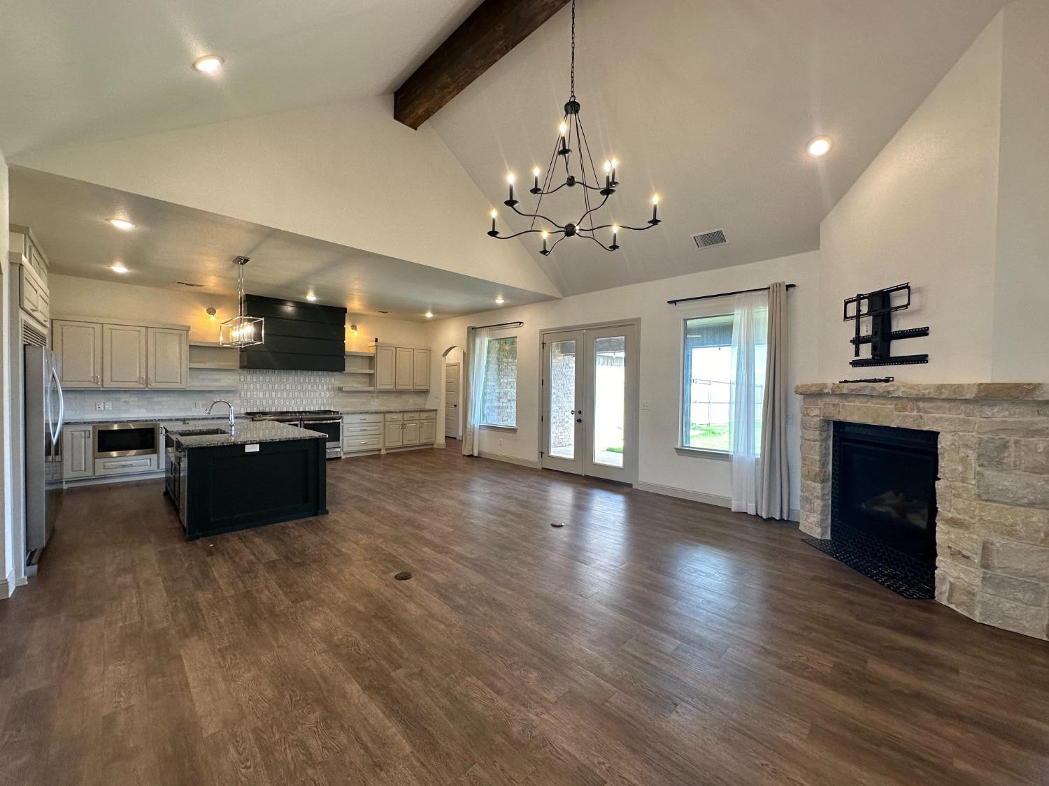 6959 103rd Street Lubbock, TX 79424 - Photo 3 of 49 a large kitchen with a center island and wooden floor