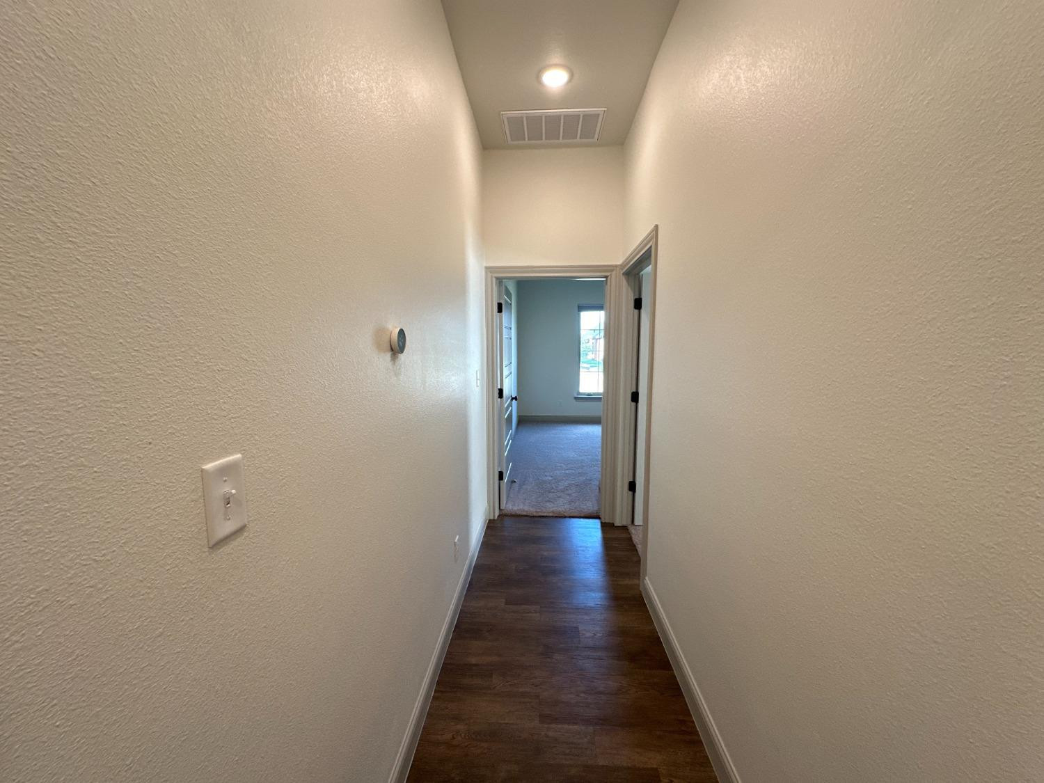 6959 103rd Street Lubbock, TX 79424 - Photo 31 of 49 a view of a hallway with wooden floor